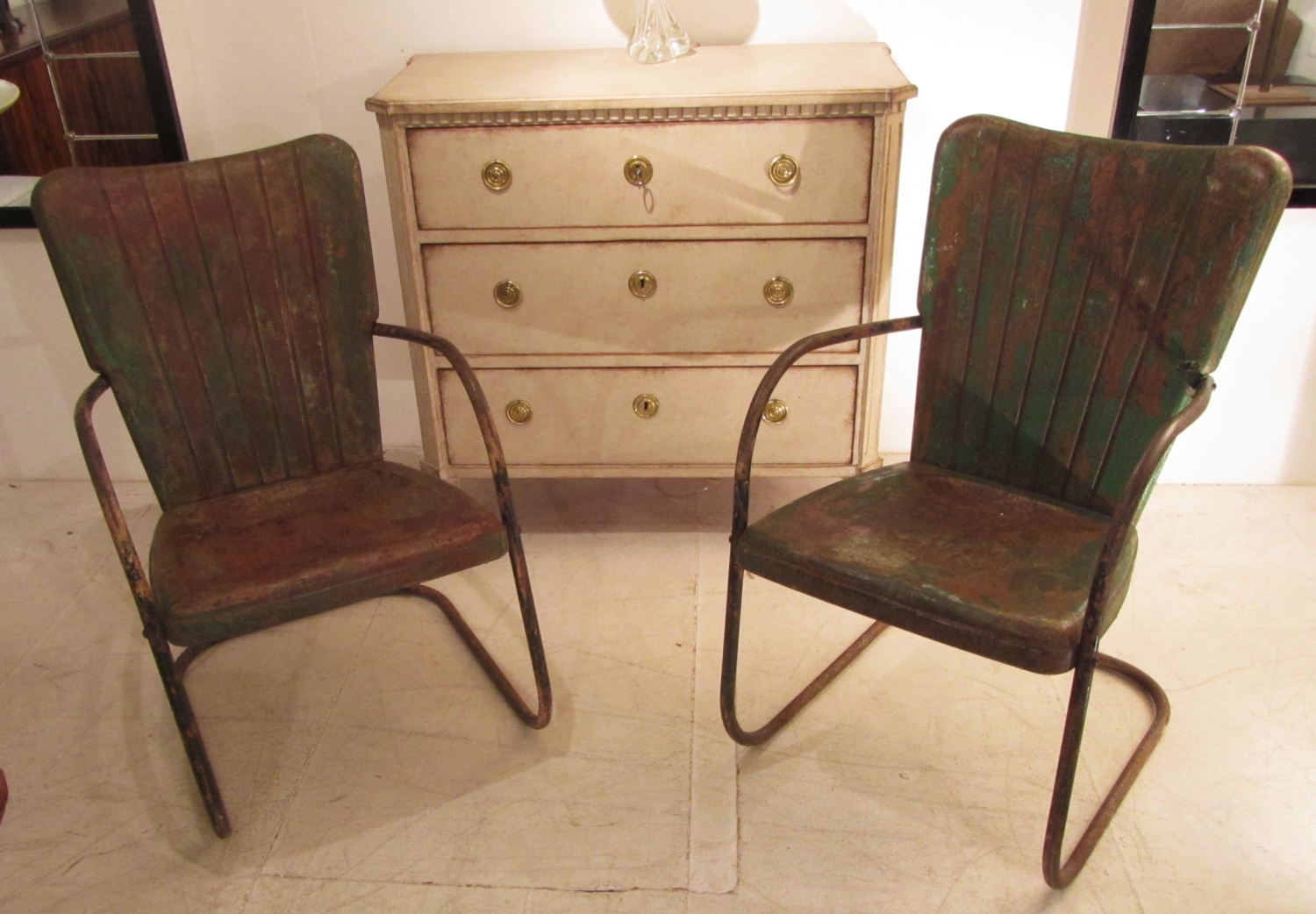 A pair of iron cafe chairs