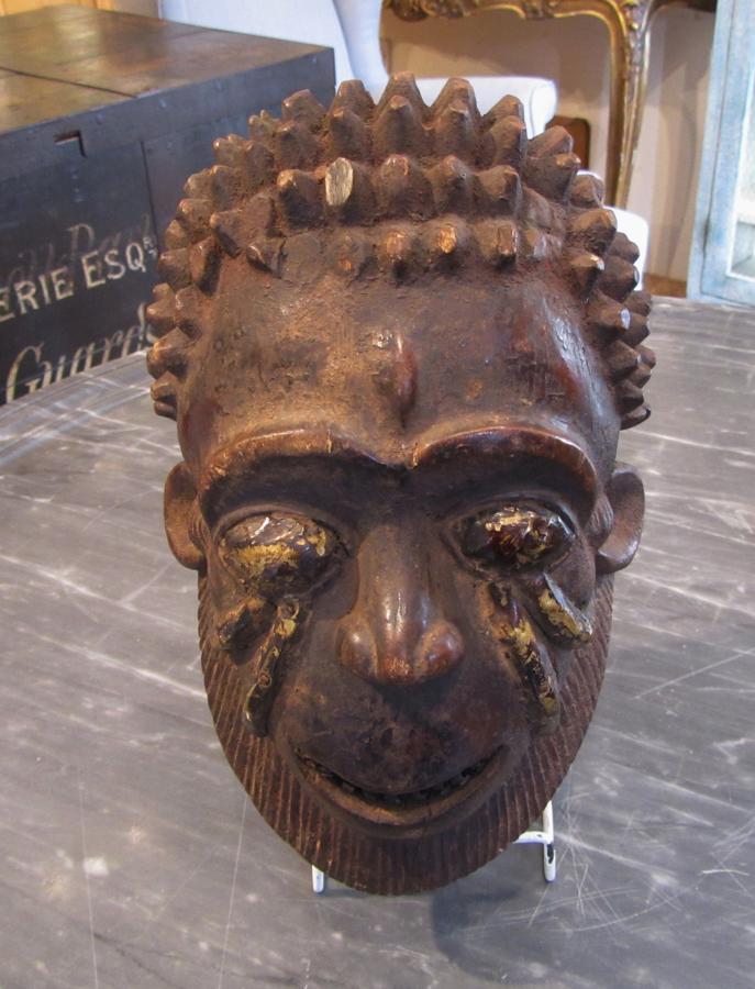 A wood and metal tribal mask