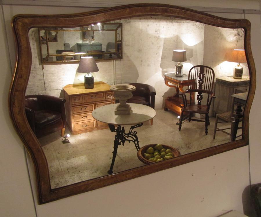 A shaped giltwood overmantle mirror