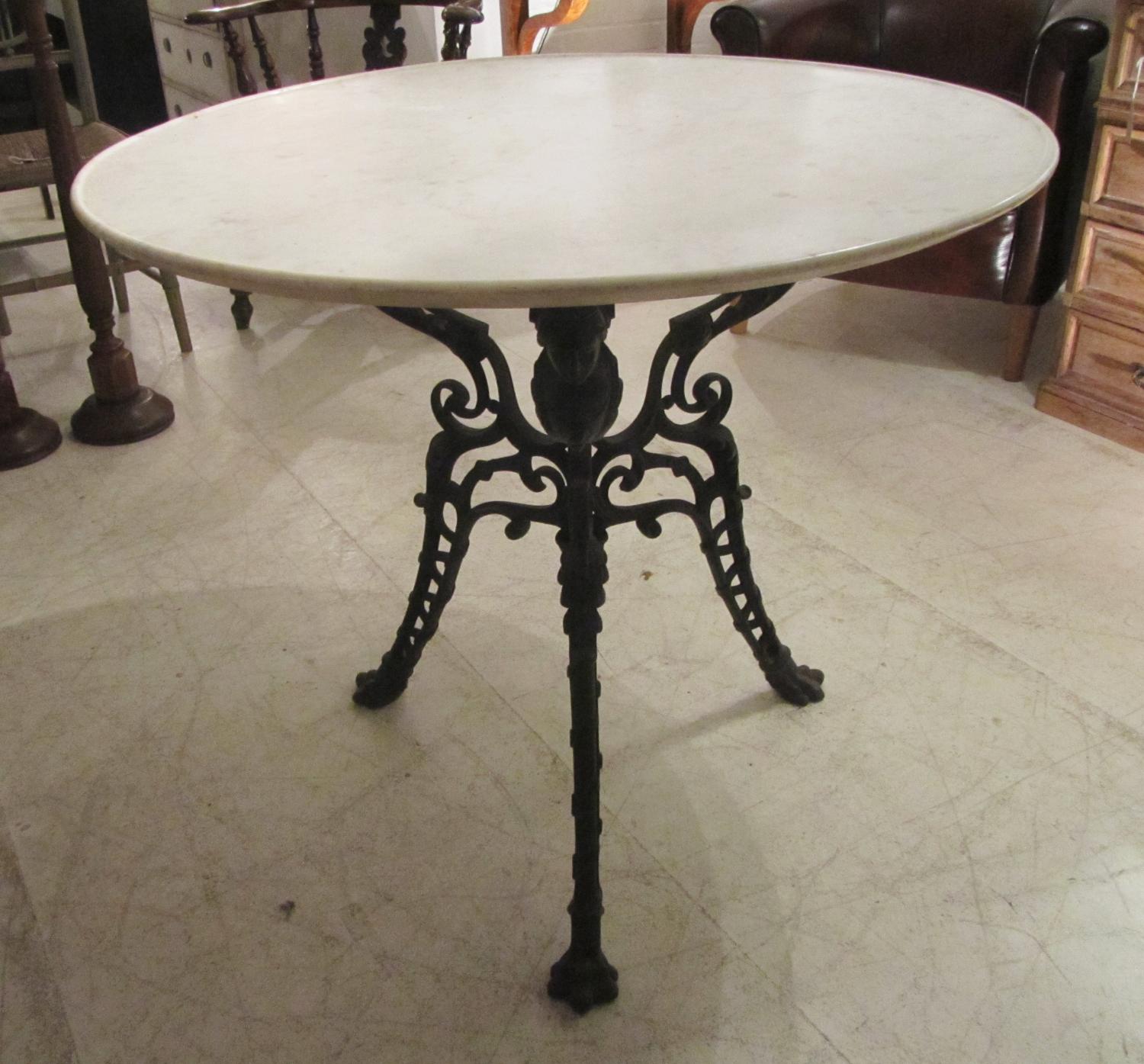 A cast iron and marble table
