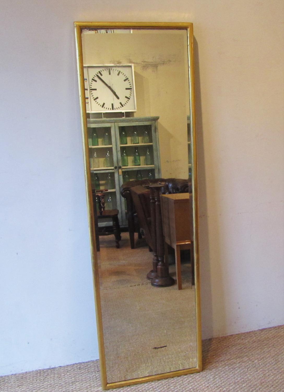 A gilded milliners shop mirror
