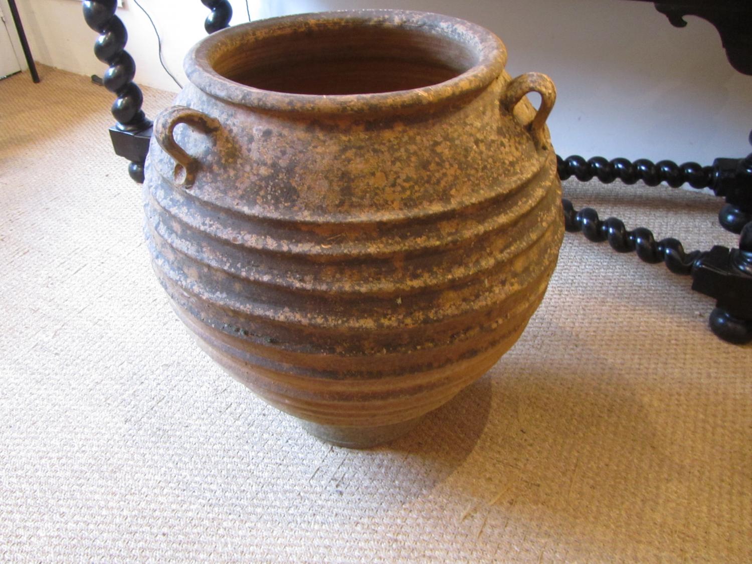 A terracotta olive oil jar