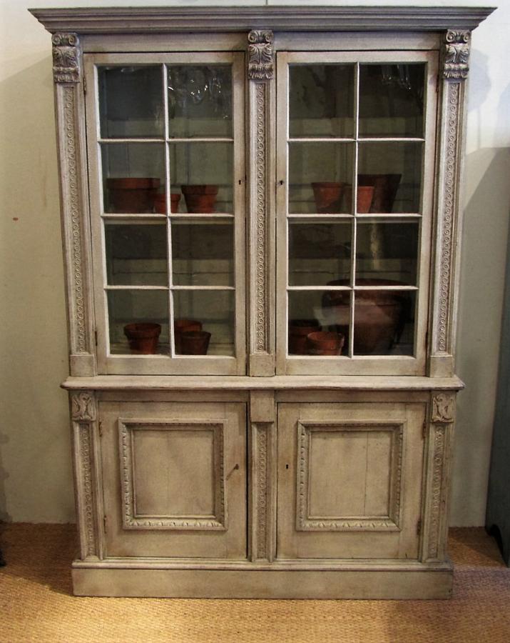 A painted glazed bookcase