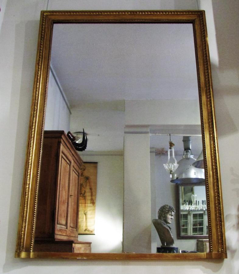 A large giltwood over mantle mirror