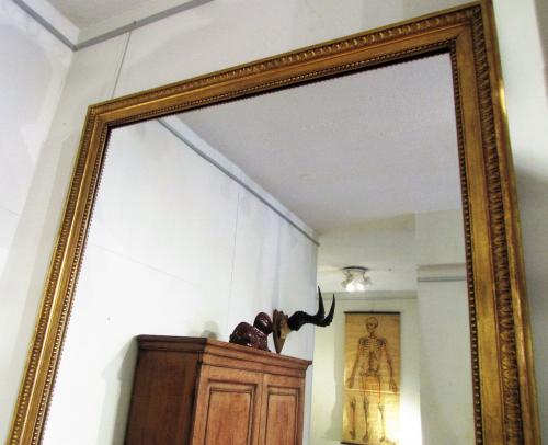 A large giltwood over mantle mirror