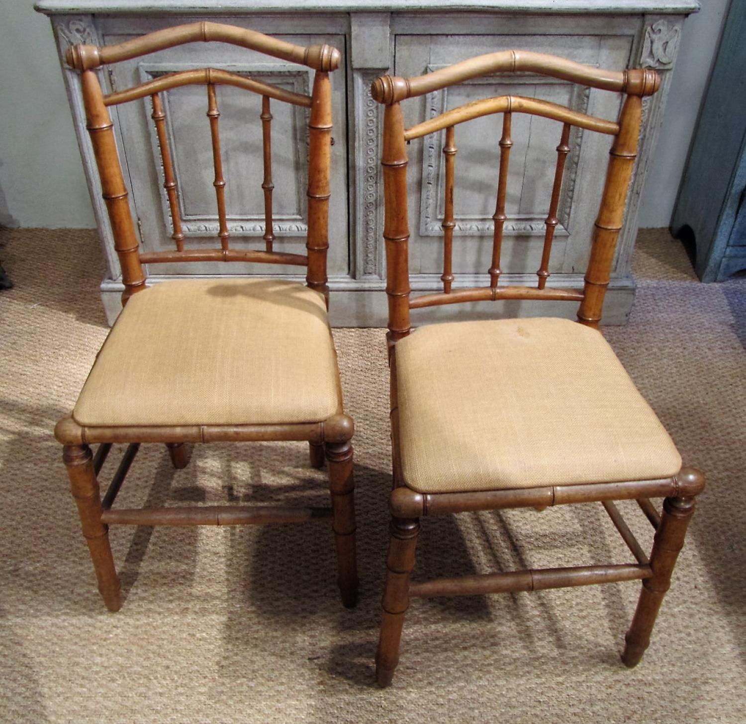 A pair of faux bamboo chairs