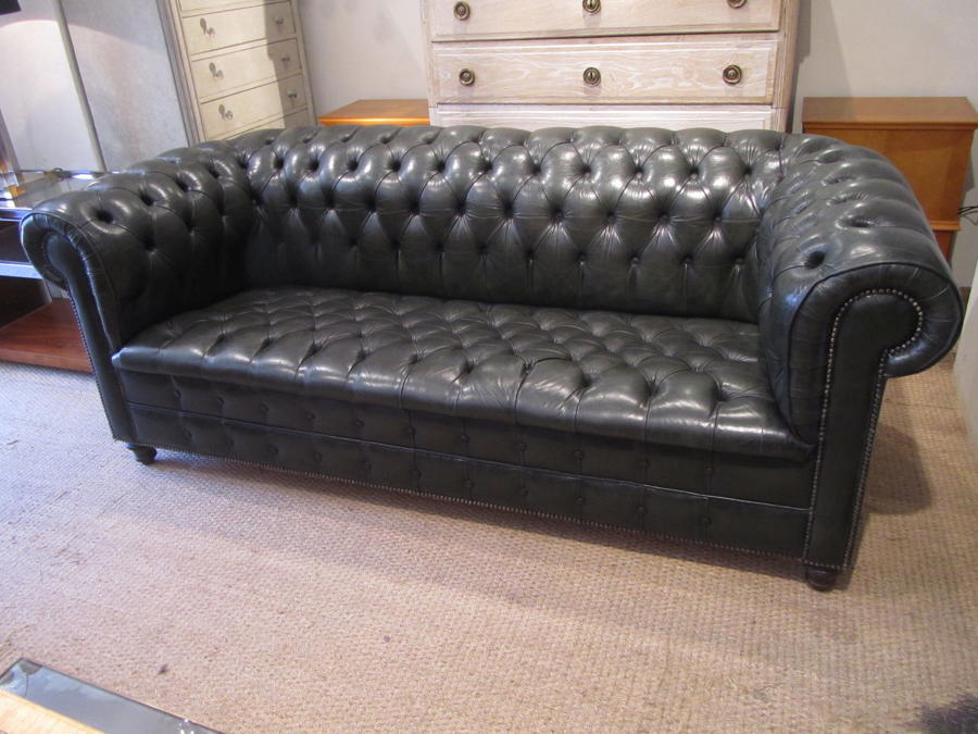 A fully buttoned leather chesterfield sofa