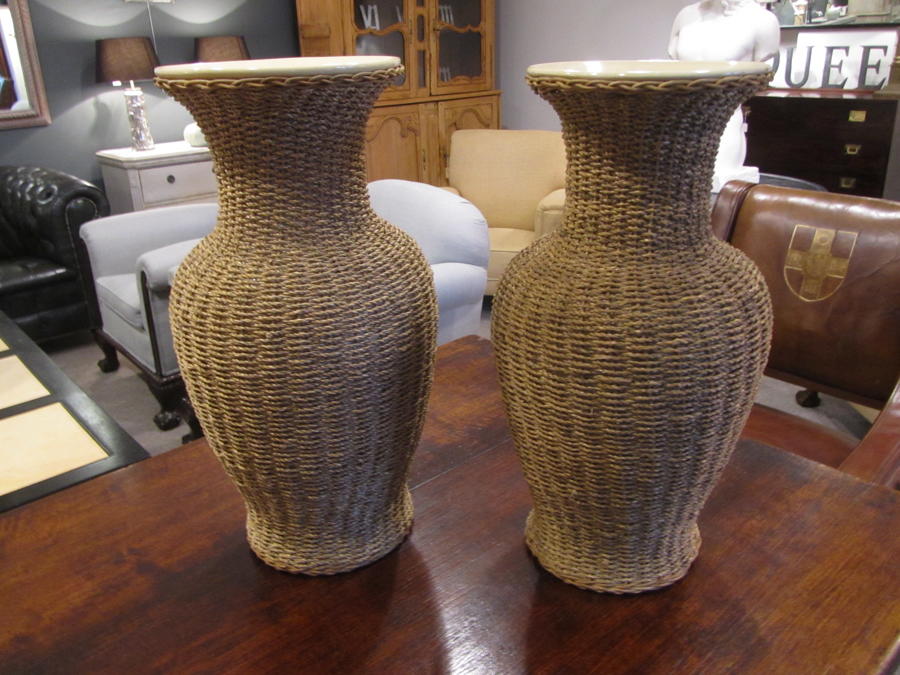 A large pair of rattan wrapped ceramic vases