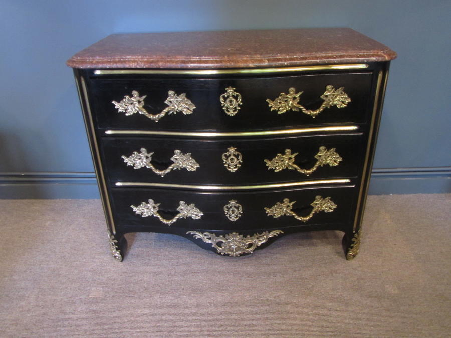A black lacquer and bronze serpentine commode