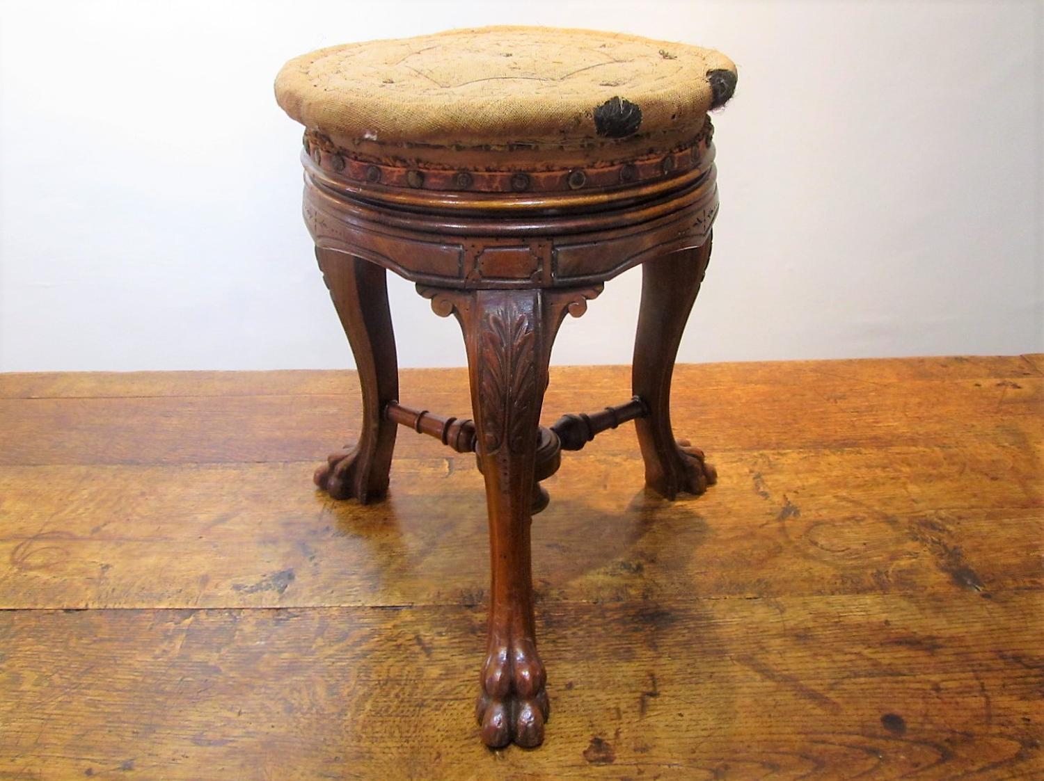 A 19thC Walnut tripod stool by Howe London