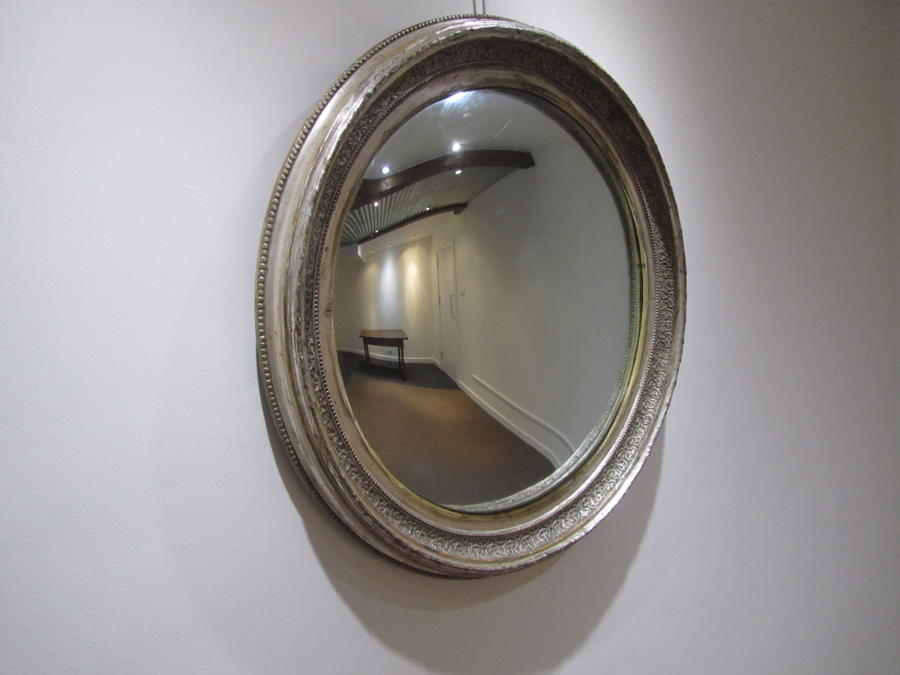 A large silver gilt convex mirror