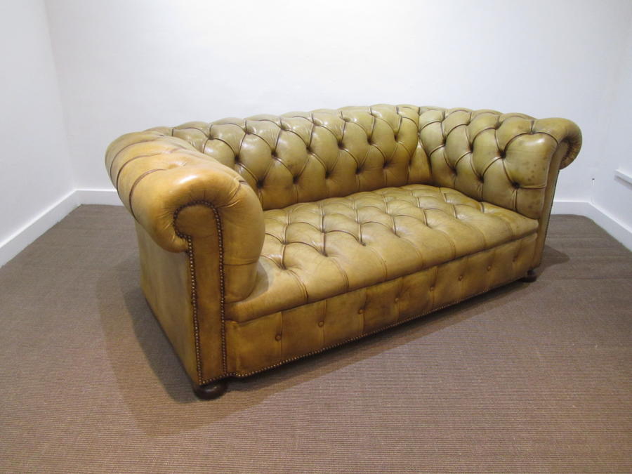A Petite leather chesterfield sofa