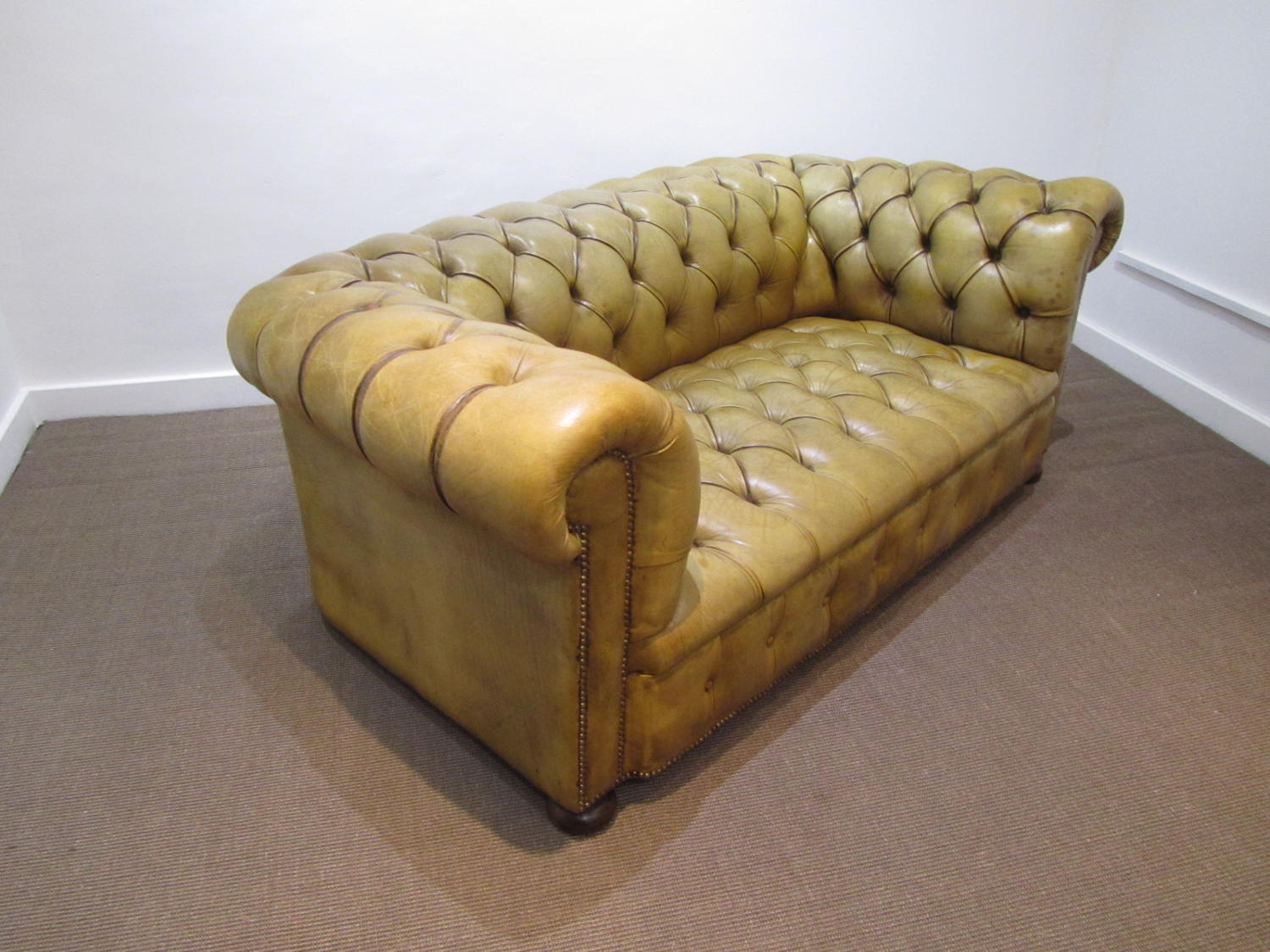 A Petite leather chesterfield sofa
