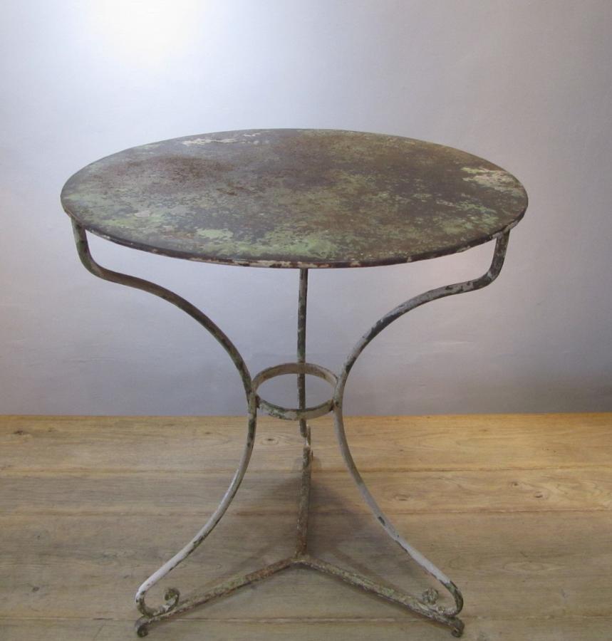 A wrought iron Gueridon table