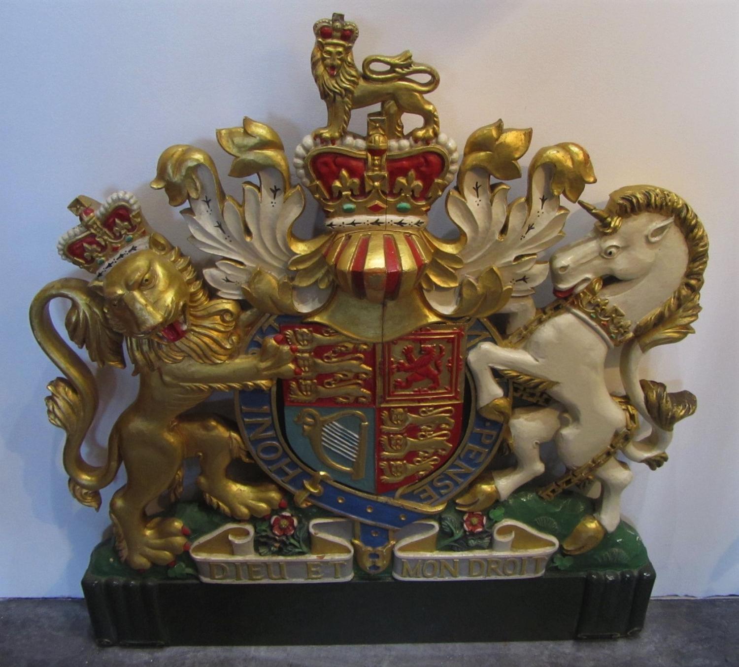 A carved wood royal coat of arms