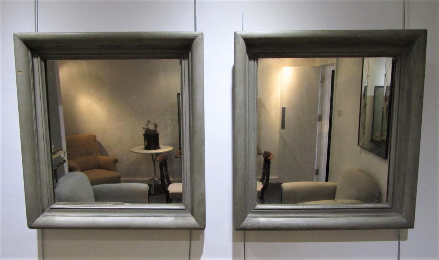 A pair of wood framed mirrors