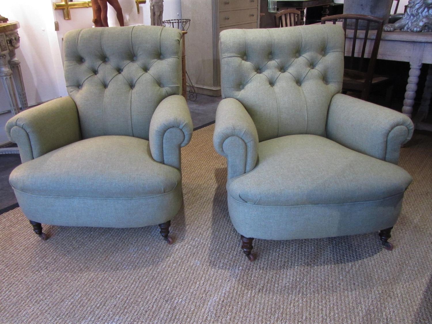 A pair of deep buttoned armchairs