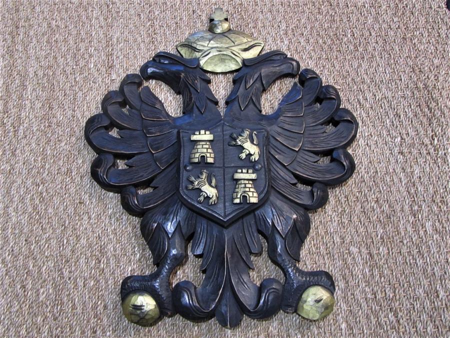 A carved wood armorial coat of arms