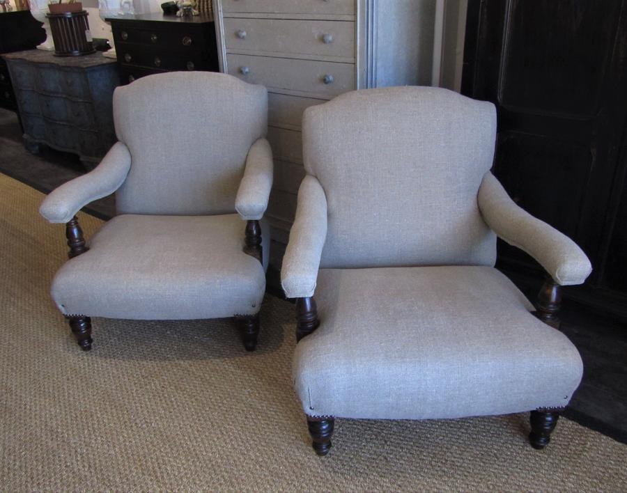 A pair of English country house open armchairs
