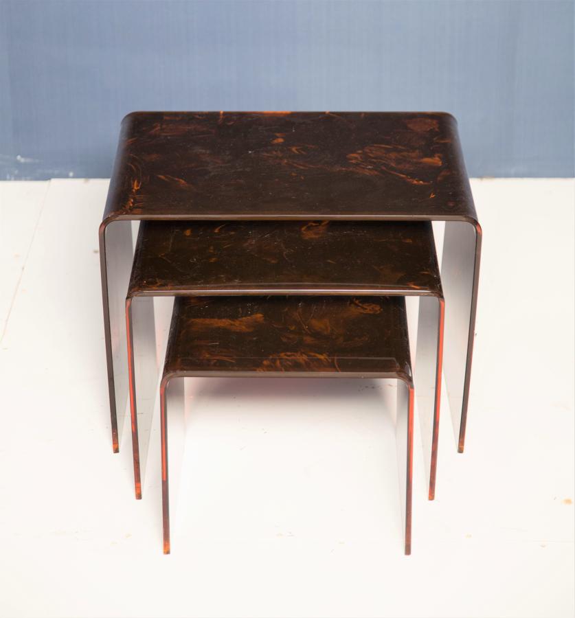 A nest of faux tortoise shell lucite tables