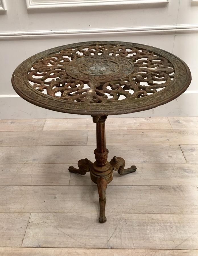 A circular cast iron garden table