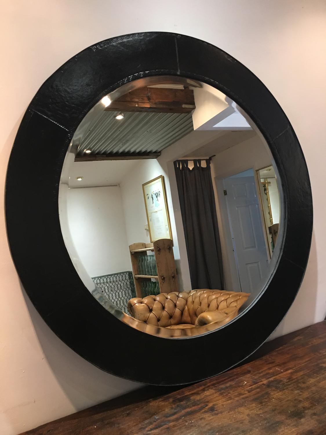 A Mid century circular leather bound mirror