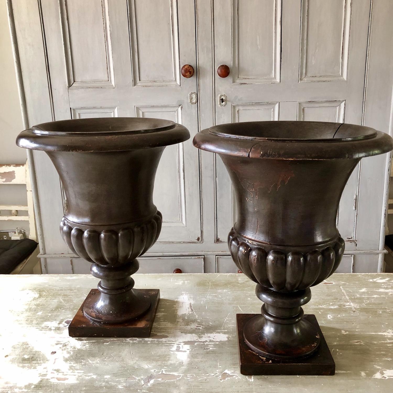 A pair of Turned and carved wood urns