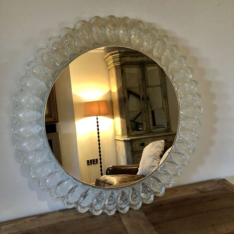 A circular lucite mirror