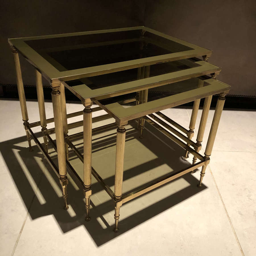 A nest of brass and glass tables