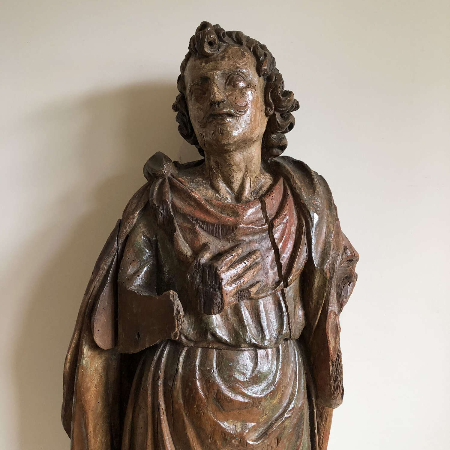 A carved lime wood figure of a saint