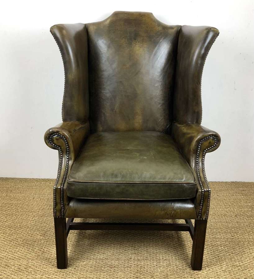 An Oversized English Leather wing armchair
