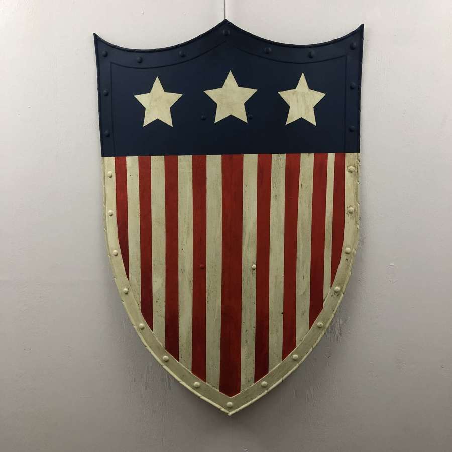 A large painted fairground shield