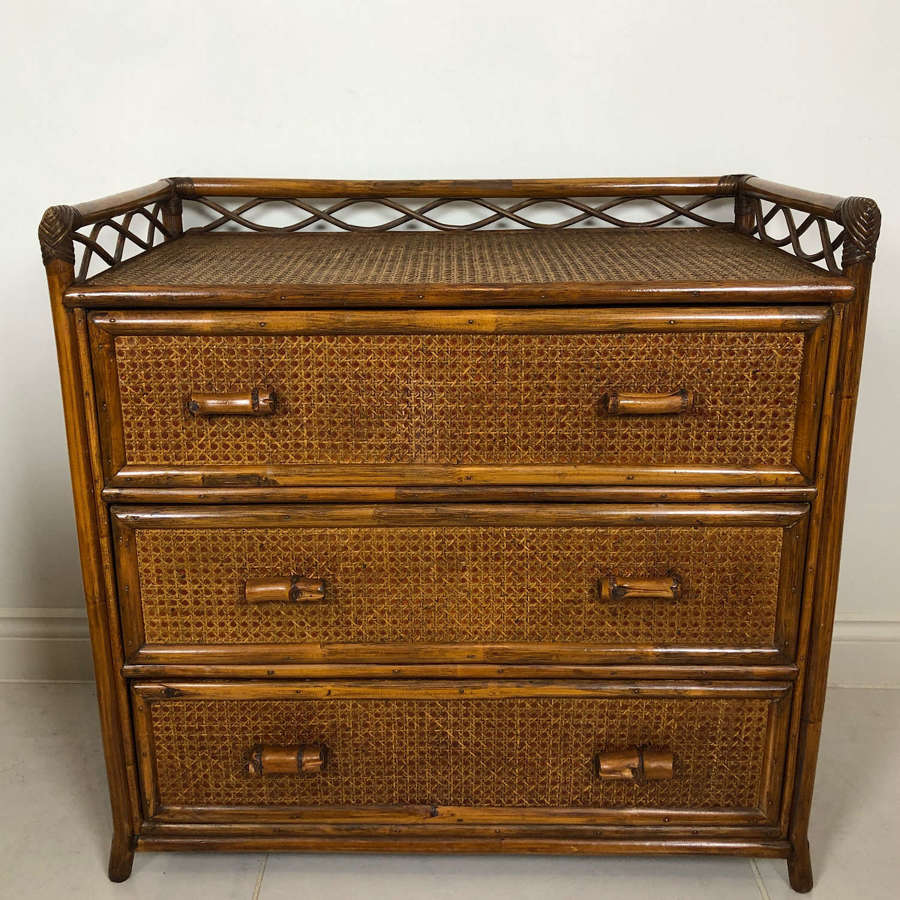 A rattan cane and bamboo chest of drawers