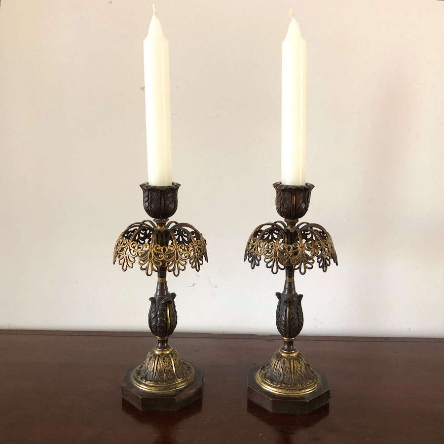 A pair of bronze candle sticks