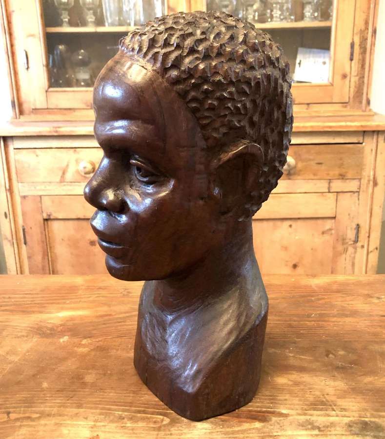A carved wooden bust