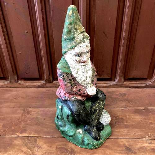 A painted cast stone garden gnome