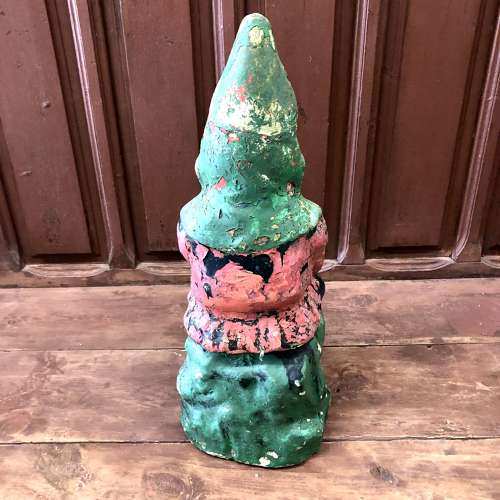 A painted cast stone garden gnome