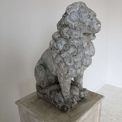 A cast stone garden lion