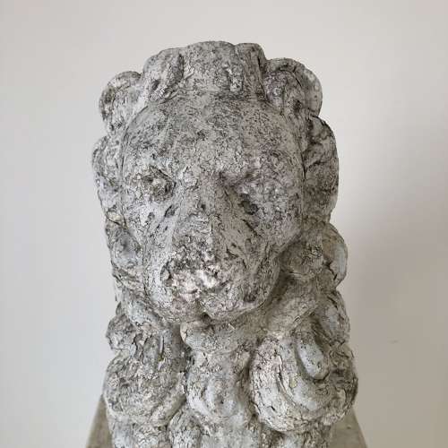 A cast stone garden lion