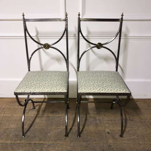 A pair of steel and brass side chairs