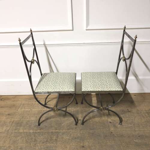 A pair of steel and brass side chairs