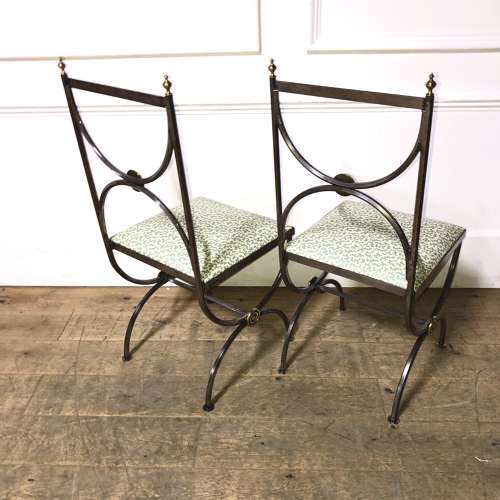A pair of steel and brass side chairs