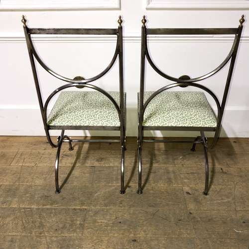 A pair of steel and brass side chairs