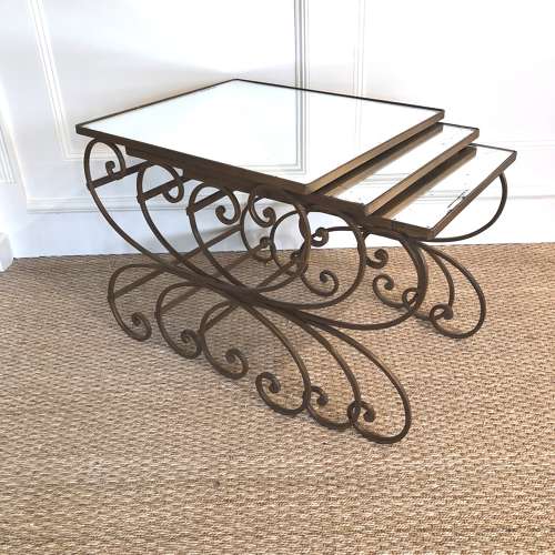 A nest of wrought iron tables